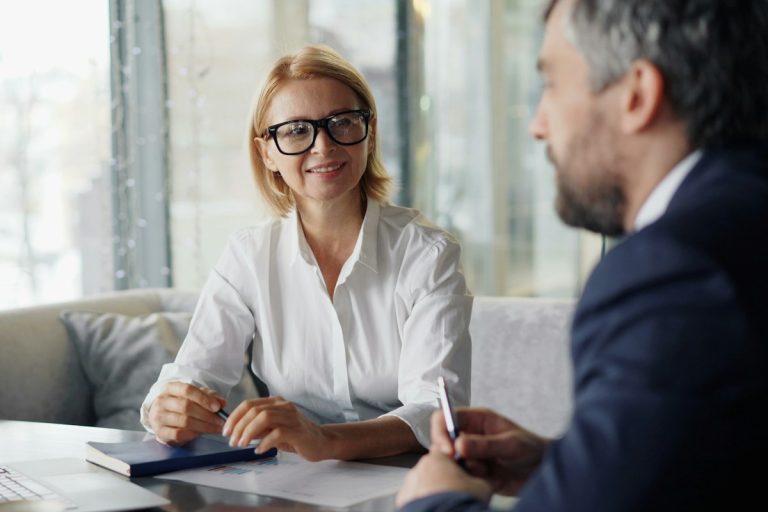 financial advisor explaining healthcare insurance policy options client modern office