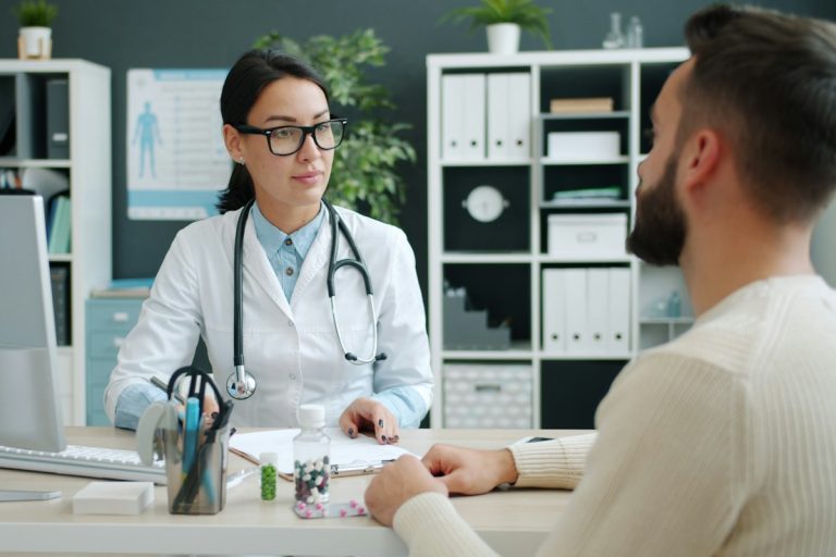 Managing Pre-Existing Condition Protections, Guaranteed Issue Mandates, and Continuous Coverage Requirements doctor consulting patient medical history clinic examination office