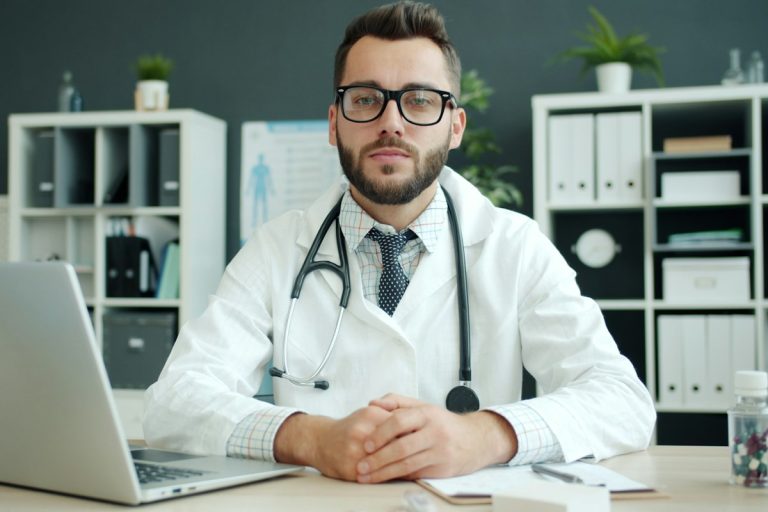 Navigating Medical Necessity Denials, External Independent Review Organizations, and Legal Appeals physician holding stethoscope medical legal consultation hospital office