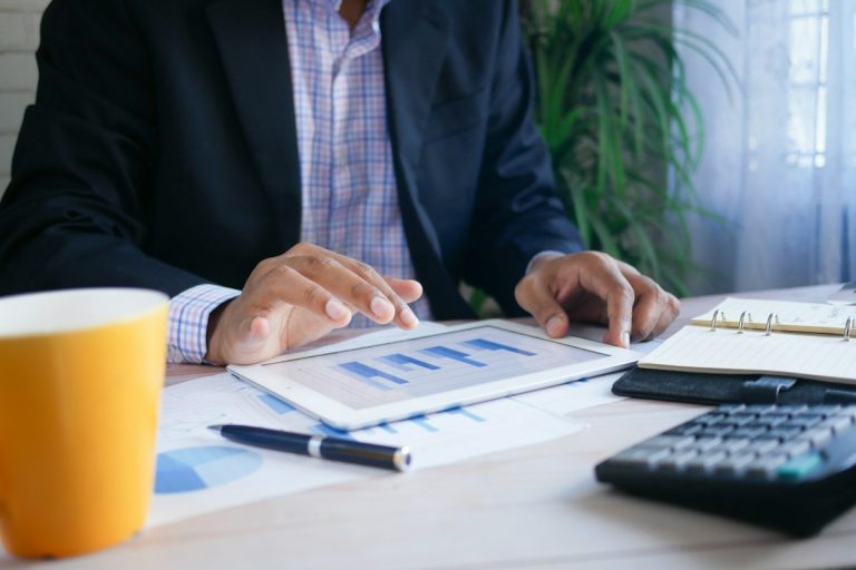 Optimizing Level-Funded Health Plans, Specific and Aggregate Stop-Loss Protection, and Surplus Dividends financial analyst reviewing healthcare insurance balance sheet numbers