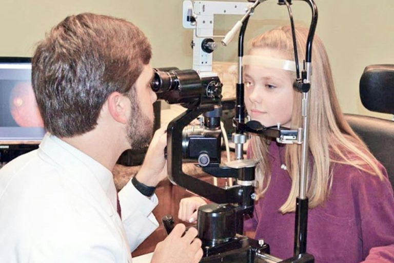 Structuring Vision Wellness Insurance Coverage for Comprehensive Ophthalmic Examinations and Lenses optometrist examining patient eyes vision clinic eyewear optical equipment