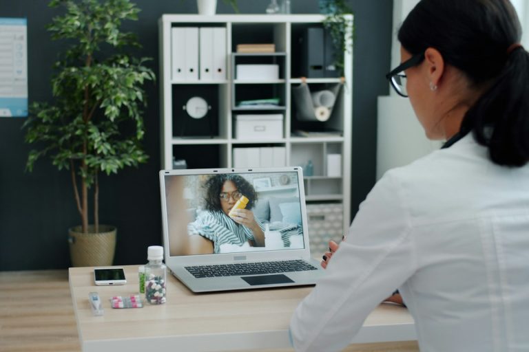 Understanding Standalone Hearing Care Insurance, Audiological Benefit Allowances, and Cochlear Device Coverage audiologist examining patient ear modern clinic hearing testing equipment